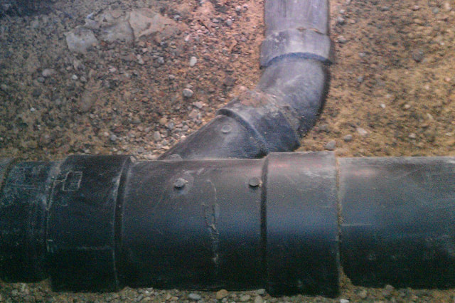 Cast-iron sewer piping repair in a drain line.