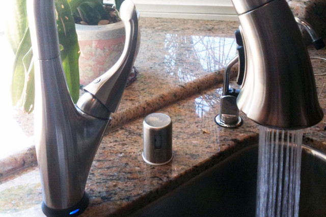 Touch-activated kitchen faucet installed for convenient hands-free water control.